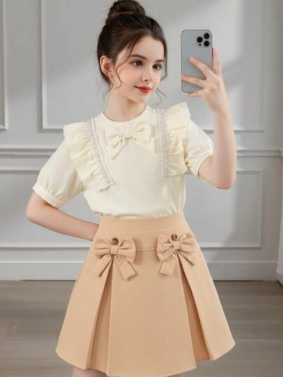 Girls Cream Sweet 2-Piece Set: Apricot Bowknot Ruffle Trim Pearl Decor Patchwork Short Sleeve Blouse + Khaki Double Bow Pleated Skirt, Gentle Princess Style Outfit For Party, Outing, Daily Wear, Suitable For 8-12 Years Old
