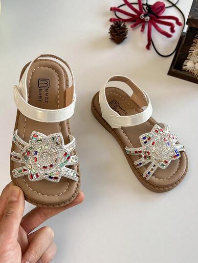 1双儿童鞋/儿童平底凉鞋，1双女童彩色水钻向日葵装饰凉鞋（鞋身饰有彩色水钻向日葵图案），防滑耐磨低帮魔术贴可调节平底童话风凉鞋，适合童话主题派对、舞台表演等场合。