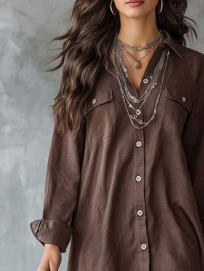 Áo sơ mi nữ dài tay màu nâu, chất liệu polyester, cài cúc, cổ bẻ, thiết kế ngắn phía trước, dài phía sau, có túi, thích hợp cho mùa xuân.