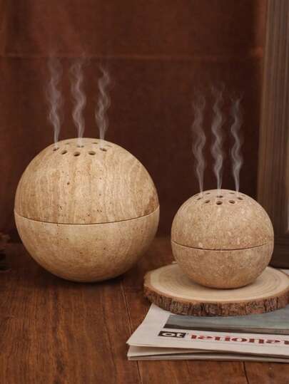 1 chiếc lư hương hình cầu kiểu Wabi-Sabi, bề mặt đá sần, có lỗ thông gió, dùng để trang trí bàn làm việc, thích hợp cho phòng khách và không gian thiền định.