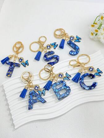 [Moda y elegante regalo] Llavero de mariposa con letra de resina con brillo de ojo de diablo azul - 26 letras disponibles, colgante con borla para bolso, regalo sorpresa para graduación/Día del maestro/Día de la madre, regalo para novia, mejor amiga, maestro, mayores