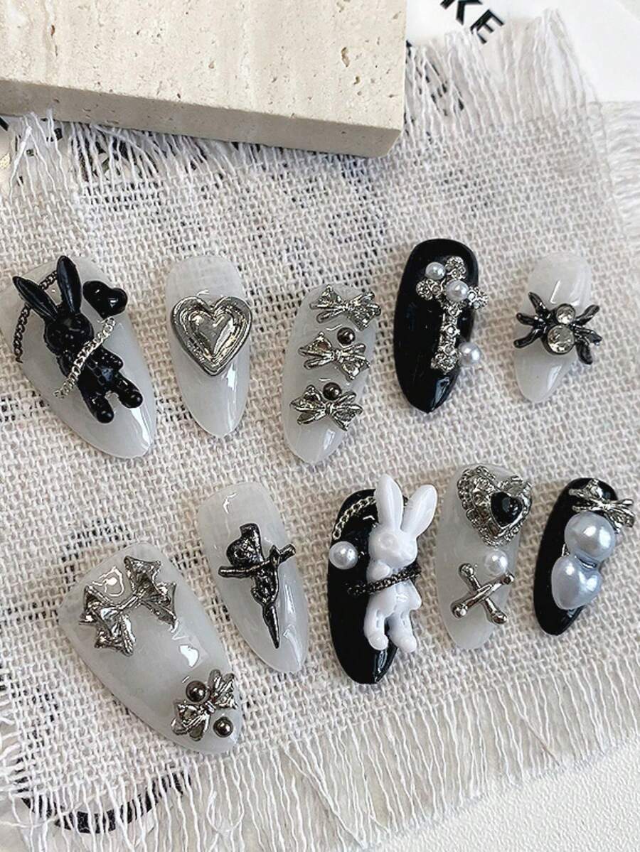 10 miếng dán móng tay hình hạnh nhân dài với họa tiết nơ kim loại hình thỏ đen trắng, được làm thủ công, có thể tháo rời và tái sử dụng, phù hợp cho phụ nữ và bé gái đeo khi lên sân khấu, dự tiệc, dạ hội và các dịp khác. - Nhiều màu - Xem 1