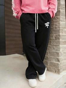 男士春夏日常休闲裤：透气舒适，十字图案宽松休闲裤，采用混色面料，十字图案装饰，弹性抽绳腰带，宽松裤脚和侧袋。是春夏日常出行和休闲放松外出的理想之选。 - 黑色 - 查看 4