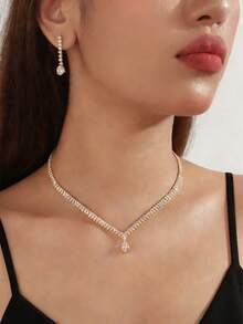 一套奢华的三件套饰品，镶嵌璀璨夺目的水晶锆石，包括一条项链和一副耳环，专为女性打造。这套饰品非常适合女性在参加派对、舞会、婚礼和其他节日活动时佩戴。优雅的锁骨链。