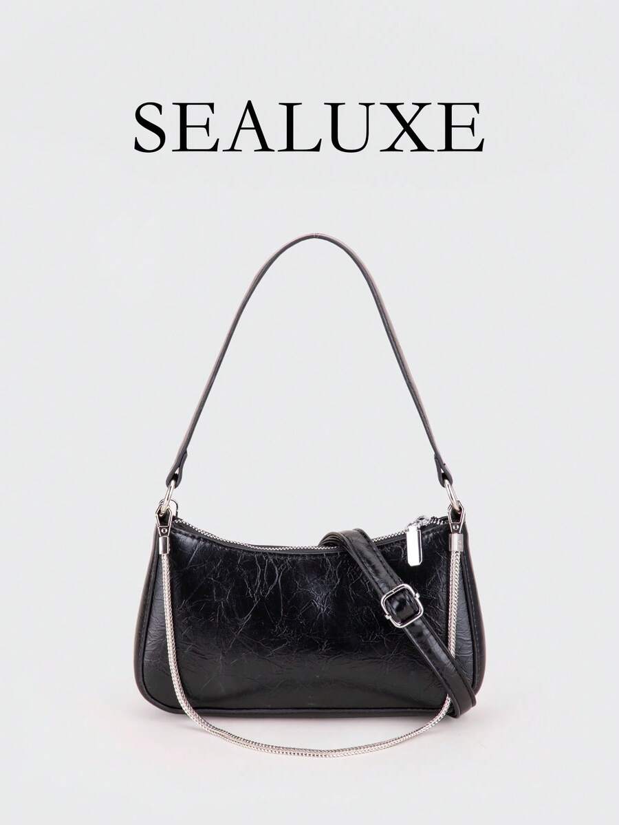 Eine zeitgenössische Tasche in Form eines französischen Baguettes, mit Metallketten-Details. Aus schwarzem PU-Leder gefertigt, bietet diese minimalistische Damen-Umhängetasche einen verstellbaren langen Riemen für das Tragen über der Schulter, was sie ideal für den täglichen Einkauf und ähnliche Anlässe macht.