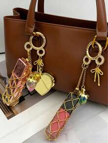 1个金色口红链袋，带网状小袋，便携式挂袋，适合存放口红、润唇膏和小物件，时尚挂式口红盒，金属口红袋挂饰，配有可替换不锈钢网袋，心形和星形装饰口红盒钥匙扣，带迷你镜子，时尚口红化妆品挂饰 - 彩色 - 查看 2