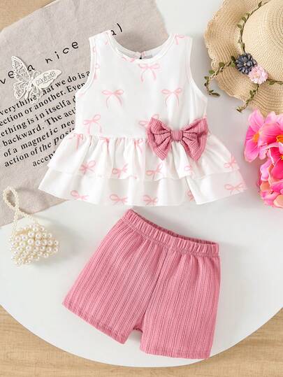 Conjunto de 2 piezas de ropa casual y dulce para niñas bebés, con parte superior sin mangas con estampado de lazos y dobladillo con doble volante, talla grande pantalones cortos sólidos y cómodos, para el verano