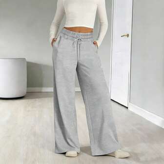 Dambyxor med vida ben, hög midja, dragsko, elastisk midja och lös passform med fickor