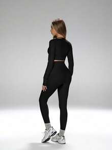 Bộ đồ thể thao năng động, thanh lịch dành cho việc tạo dáng bụng thon gọn, bao gồm áo crop top hở eo có lỗ xỏ ngón tay cái, quần legging ôm sát cạp cao và áo ngực thể thao có đệm có thể tháo rời. - màu đen - Xem 3