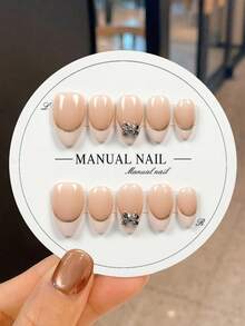 JUTI 10 piezas de uñas postizas cortas de almendra 100% hechas a mano y pintadas a mano | Rosa nude con borde dorado fino, decoración de lazo de strass dibujado a mano, arte de uñas de moda, lujoso, delicado, suave y elegante | Reutilizables para uso diario y reuniones de té de la tarde - Multicolor - Ver 1