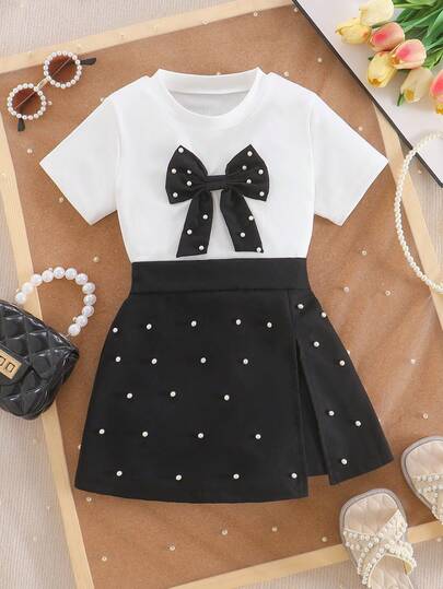 女童复古优雅圆领白色短袖上衣，饰有蝴蝶结和珍珠，搭配不对称下摆珍珠装饰半身裙，两件套，春夏款