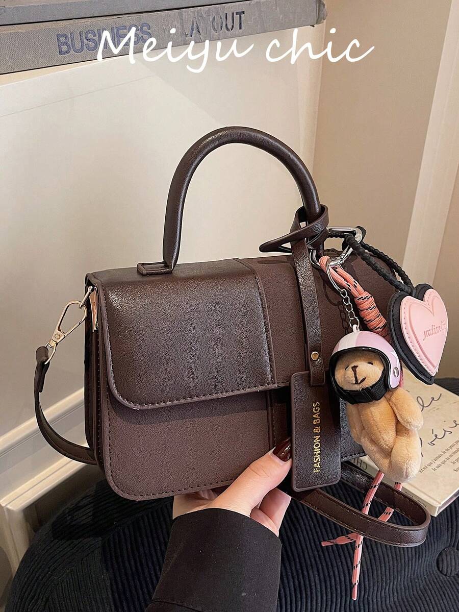 This Fashionable New Classic Women's Handbag Is Made Of Brown Fabric, Featuring A Patchwork Design, Letter Graphics, And A Helmet Bear Pendant. Available In Square And Shoulder Strap Styles, It Is An Ideal Choice For Shopping, Parties, And Dates.