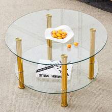 Modern Two-Tiered Glass Coffee Table With Gold Metal Legs, Stable And Spacious, With A Light And Luxurious Design. The Metallic Sheen And The Reflections Of The Glass Harmonize Beautifully To Create Interiors Of Understated Luxury.