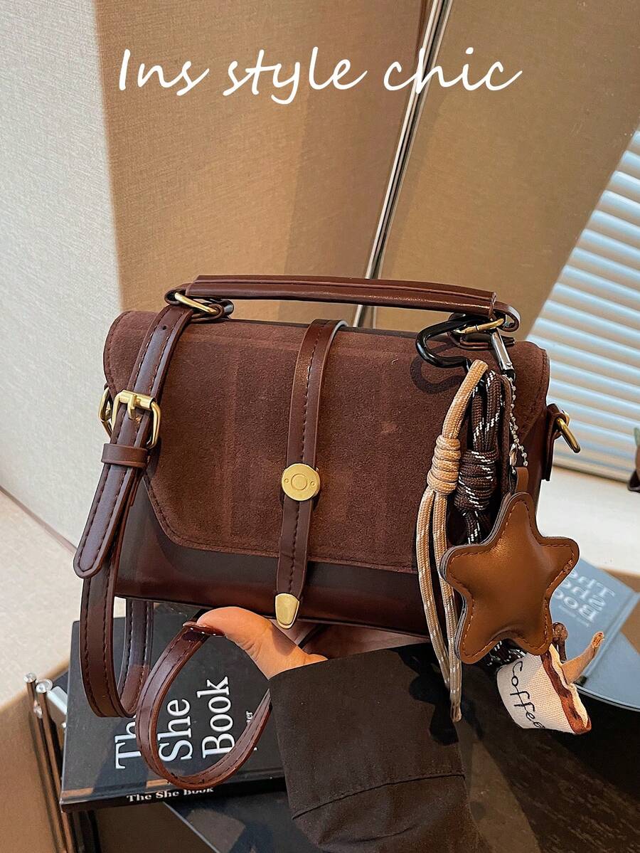 这款时尚经典的新款方形手提包采用金属扣环、可调节肩带、翻盖设计，并饰有咖啡杯吊饰。非常适合户外活动、通勤、购物、学校旅行和短途旅行。