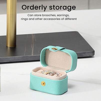Compact Faux Leather Jewelry Organizer: Mini Travel Case For Storing Earrings And Rings In An Elegant Blue Color.