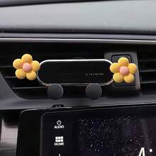A Mobile Phone Holder For That Features A Daisy Design With Five Petals, Serving As Both A Navigation Aid And An Interior Air Vent Decoration
