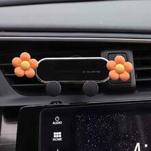 A Mobile Phone Holder For That Features A Daisy Design With Five Petals, Serving As Both A Navigation Aid And An Interior Air Vent Decoration