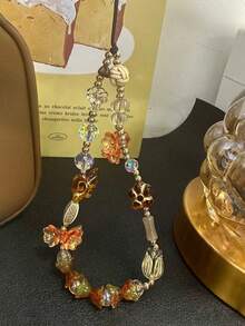 异域风情铃铛花手机挂饰，时尚腕间装饰，适合女性，可搭配手机壳、钥匙扣，适用于户外旅行、购物等多种场合，百搭设计 - 棕色 - 查看 8