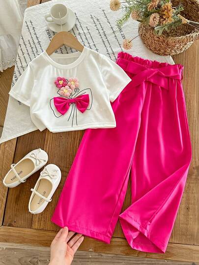 Bộ trang phục ngày lễ ngọt ngào cho bé gái: Áo thun ngắn tay in hình nơ hoa 3D + quần ống rộng, eo chun xếp ly, mềm mại và thoáng khí, phong cách giản dị và thời trang kiểu Âu Mỹ.