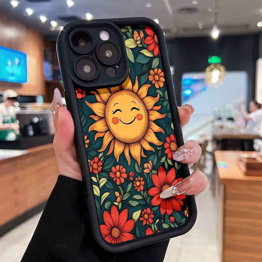 Sol radiante rodeado de coloridas flores y hojas. Esta elegante funda es compatible con los modelos  17, 16, 15, 14 Pro Max, 13, 12, 11, XR y XS Plus. Fabricada en silicona TPU, ofrece protección contra golpes y caídas, además de una sensación superior. Es un regalo ideal para familiares, amigos y seres queridos, y la elección perfecta para Año Nuevo. - Negro - Ver 1