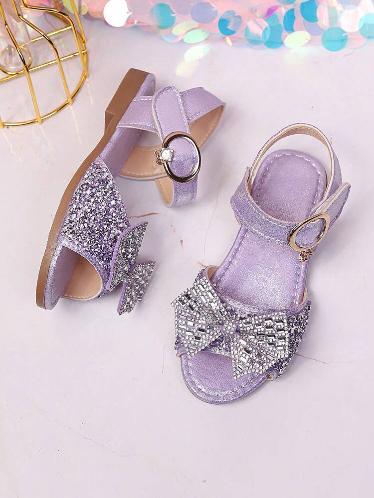 1 Đôi dép xăng đan cổ điển cho bé gái với nơ rỗng và đá đính, kiểu dáng ngọt ngào, đế cao su chống trượt, hở mũi, thoáng khí, thời trang, thích hợp cho tiệc tùng, kỳ nghỉ, dép xăng đan hở ngón thoáng khí, đế mềm chống trượt. - Màu tím - Xem 4