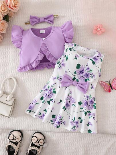 Bộ đồ hai mảnh dành cho bé gái, gồm một chiếc váy in hoa màu tím và một chiếc áo khoác len dệt kim.