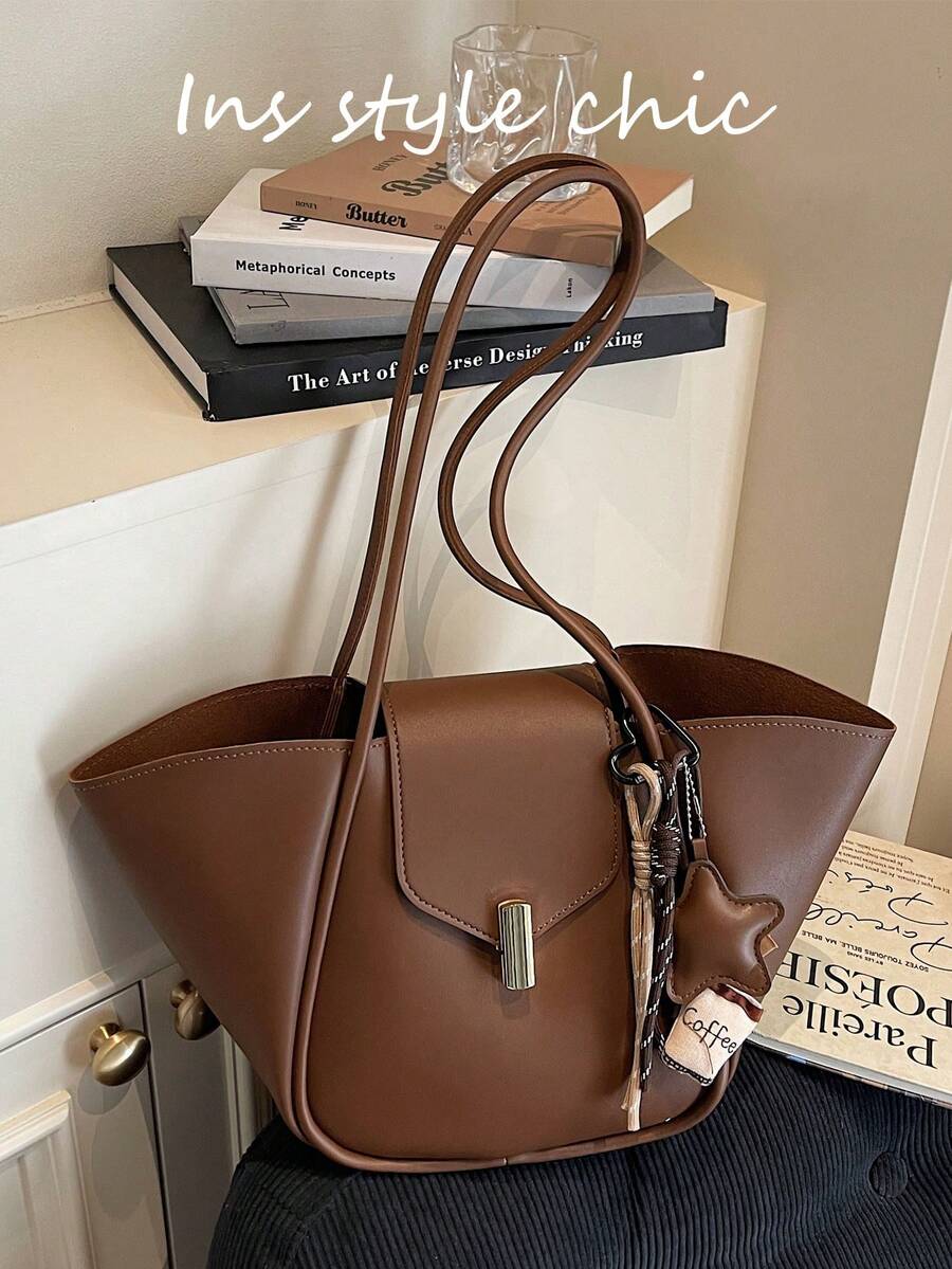 这款高品质、时尚百搭的纯棕色PU皮手提包，内部空间宽敞。它采用外部咖啡杯套设计，展现出精致的复古风格。包身配有磁扣和双提手，方便您肩背或手提。 - 咖啡 - 查看 1