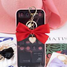 1个布艺蝴蝶结和仿珍珠心形钥匙扣，适合作为生日礼物、情人节礼物、汽车装饰、包包挂饰或情侣或女友的学习用品。 - 兔耳蝴蝶結 - 查看 10