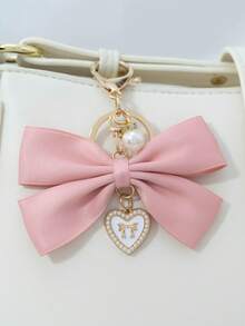 1个布艺蝴蝶结和仿珍珠心形钥匙扣，适合作为生日礼物、情人节礼物、汽车装饰、包包挂饰或情侣或女友的学习用品。 - 兔耳蝴蝶結 - 查看 19