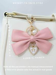 1个布艺蝴蝶结和仿珍珠心形钥匙扣，适合作为生日礼物、情人节礼物、汽车装饰、包包挂饰或情侣或女友的学习用品。 - 兔耳蝴蝶結 - 查看 4