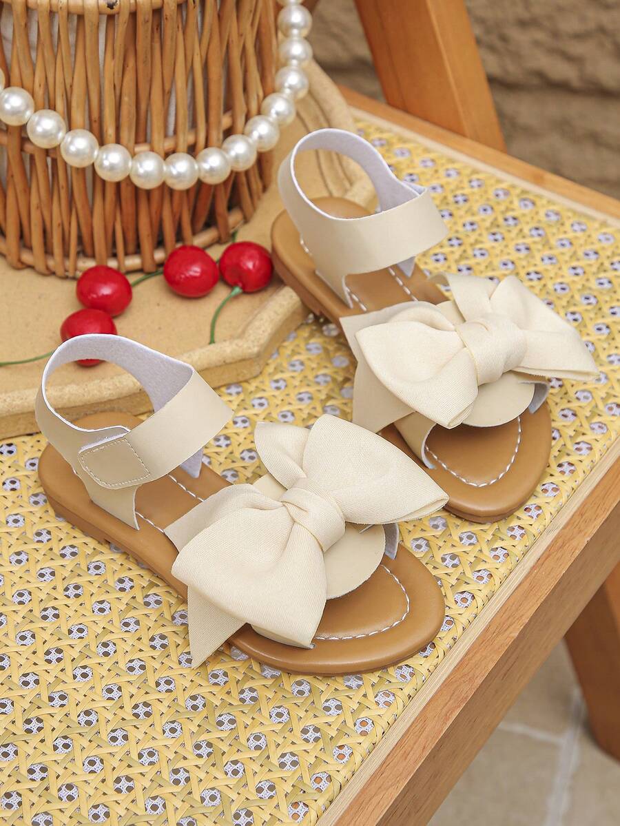 1 đôi dép xăng đan đế bằng mũi bướm mới cho bé gái mùa xuân và hè, giày công chúa dễ thương đa năng cho trẻ em, giày La Mã chống trượt phù hợp cho du lịch, kỳ nghỉ và đi học. - Màu be - Xem 1