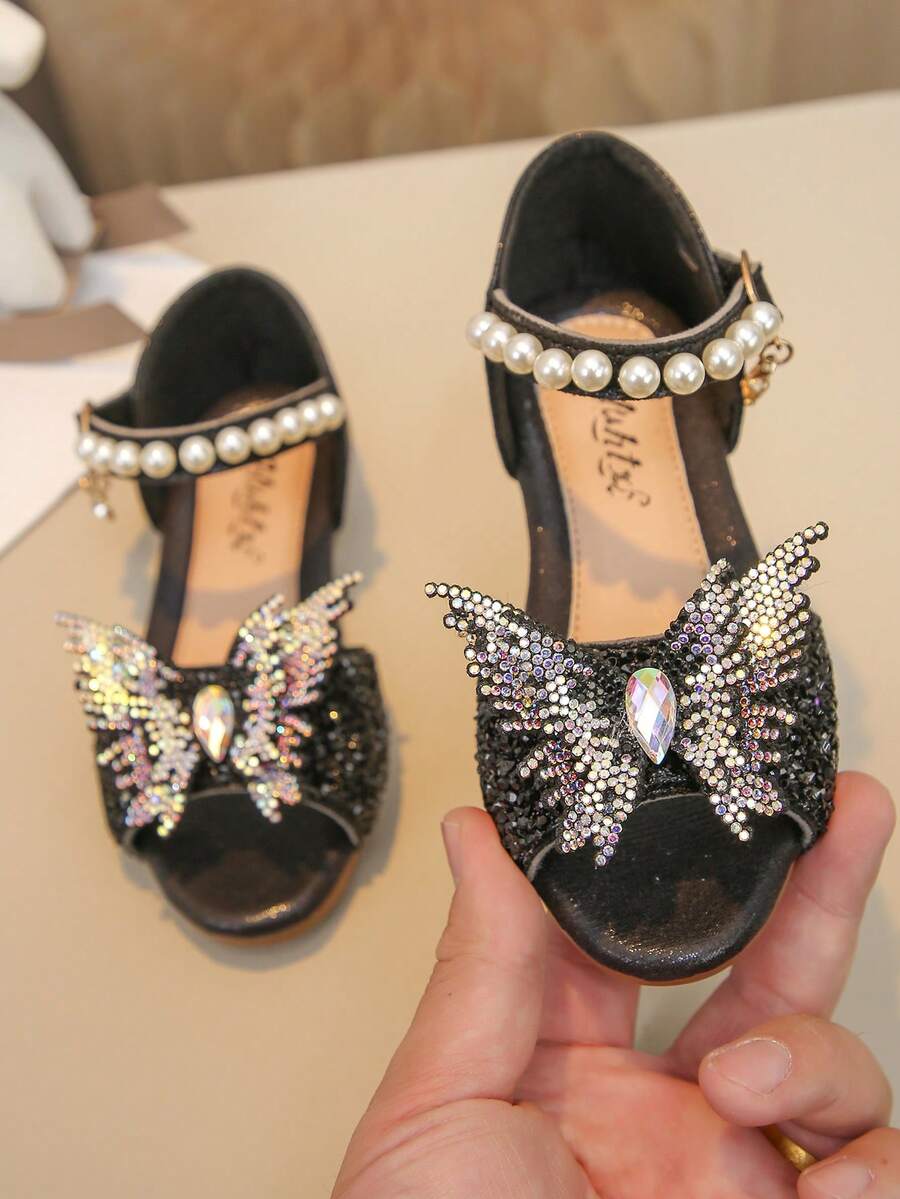 1 par de sandálias infantis com strass, pérolas, laço decorativo, bico redondo em PU com detalhes em patchwork, ideais para uso diário, dança, atividades ao ar livre, festivais e festas. Sapatos de princesa com glitter, perfeitos para primavera, verão e outono. - Preto - Ver 1