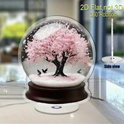 2D平面360°旋转樱花树雪花球，采用高分子材料制成，经典造型，无需用电，适合家居装饰，也适用于情人节、复活节、万圣节和毕业季等场合。