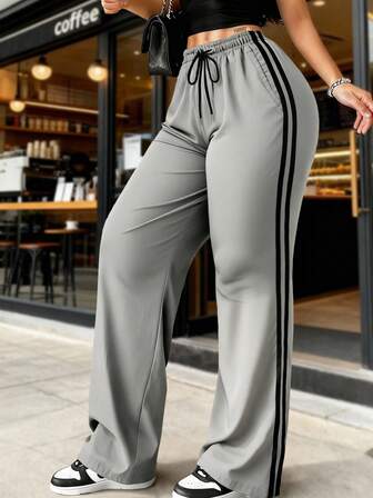 Calça feminina casual estilo americano listrada, pernas largas, cintura com cordão, modelagem solta, elegante e minimalista, ideal para esportes ao ar livre e uso diário.