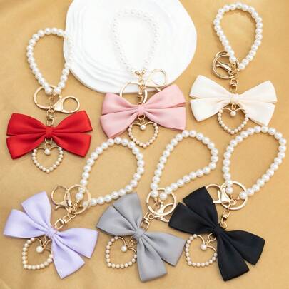 1 pièce Nœud en tissu et porte-clés en forme de cœur avec fausse perle, convient comme cadeau d'anniversaire, cadeau de la Saint-Valentin, décoration de voiture, charm de sac ou fournitures scolaires pour les couples ou les petites amies, cadeaux pour la mère, le père, la remise des diplômes et l'enseignant