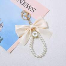 1 chiếc móc khóa trang trí hình nơ ngọc trai giả thanh lịch, kết hợp với ruy băng dệt nhiều màu sắc sáng tạo, thích hợp làm phụ kiện tai nghe, ốp điện thoại, trang trí xe hơi dịp Giáng sinh, phụ kiện túi xách, đầy ngọc trai, mang phong cách Gothic Y2K dễ thương. - nơ đính cườm - Xem 7