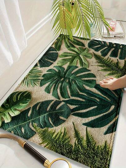 这款长方形地毯采用仿羊毛面料制成，饰有热带绿色植物图案。它可水洗且吸水性强，适合卧室、厨房或门厅等家居装饰。四季皆宜，也是一份很棒的礼物。