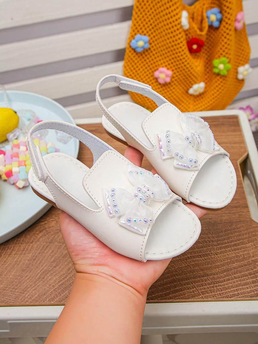 1双女童春夏新款蝴蝶结水钻软底露趾平底公主凉鞋，儿童多功能防滑罗马鞋，适合旅行、度假和上学穿着 - 白色 - 查看 1