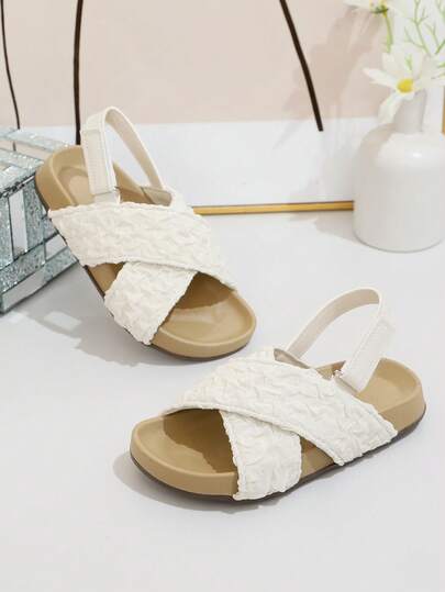 A Pair Of The Latest Summer Children's Pleated Net Fabric Cross-Strip Flat Sandals - In White Design. An Excellent Choice For Daily Outings, Shopping In Malls, Summer Vacations