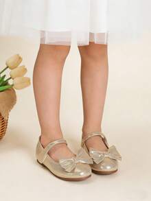 A Pair Of Gold Girls' Shoes With Bows - Zapatos Para Niña,Kids Shoes,Girls Shoes,Toddler Girl Shoes,Shoes,Shoes Kids Girls,Zapatos De Niña,Girl Shoes,Toddler Shoes,Shoes For Girls,Kids Shoes Girls,Zapatos De Niño,Toddler Shoes Girls,Kids,Girls Dress Shoes,Shoes For Kids Girl,Little Girl Shoes,Girl Shoes For Kids,Flats,Zapatos Para Niñas,Ballet,Ballet Shoes,Dance,Ballet Flats,Pointe Shoes Ballet,Ballerina Shoes,Little Girl Shoes,Mary Jane Shoes Girls,Ballerina Flat Shoes,Girls Mary Jane Shoes,Cheer Shoes,Point Shoes Ballet,Flower Girl Shoes  For Toddler & Little Girls | Ideal For Christmas,Holiday Parties,New Year Celebrations,Weddings,Birthday Parties,Church Events,Outings,Family Gatherings,Special Occasions