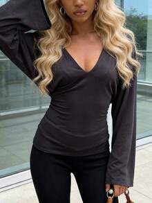 Elegant Women's Black Knit Top With Deep V-Neck And Flared Long Sleeves, Comfortable And Stretchy Fabric
