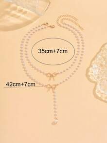 浪漫甜美的女士金属首饰两件套，包括一条饰有蝴蝶结的锁骨链和一条百搭的仿珍珠流苏项链。时尚百搭，既可单独佩戴，也可叠戴。 - 白色 - 查看 4