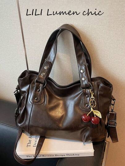 New Fashion Solid Color PU Leather Coffee Women's Handbag, Large Interior Space, Decorated With Red Cherry Pendant Externally. Stylish And Versatile Design, Smooth Metal Zipper, Dual Top Handles, Can Be Shoulder Bag, Handheld Or Crossbody.