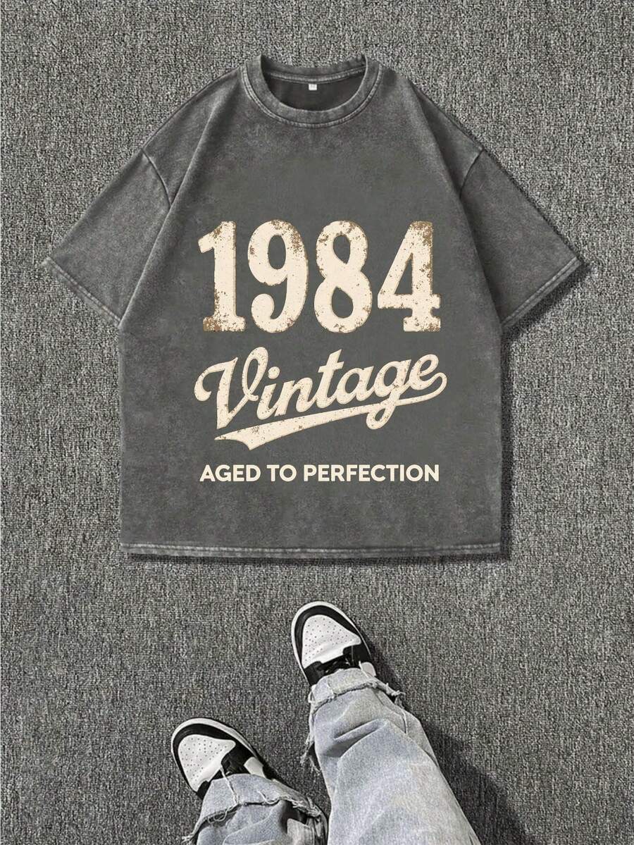 1984 Vintage Oversized T-Shirt - Aged To Perfection Stone-Washed Retro Distressed Black Tee With Vintage Print, Unisex Loose Fit Casual Streetwear For Men & Women, All-Season Comfort, Durable Hot Transfer Graphic - Xám - Xem 1