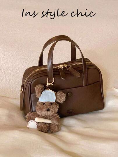 Southwind Burn Post 枕头包是一款非常受欢迎的女性通勤包，可作为手提包、单肩包或斜挎包使用，采用纯色 PU 材质，咖啡色，保龄球包风格。