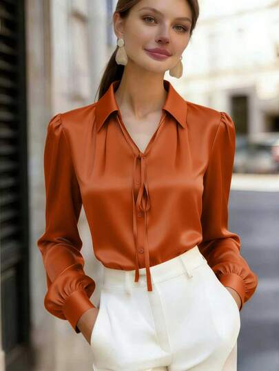 Áo sơ mi nữ tay dài cổ bẻ bằng polyester, có chi tiết thắt nơ phía trước và cúc cài, dáng regular fit, thanh lịch, thích hợp cho mùa xuân.