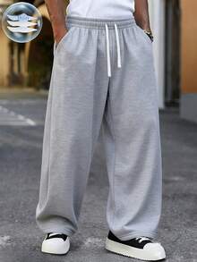 男士宽松休闲纯色阔腿裤，带抽绳腰带和大口袋，适合日常行走、工作、旅行和其他场合。