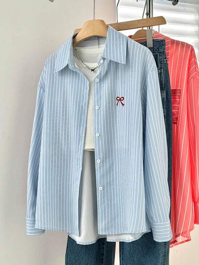 Damesblouse met strepen, knoopsluiting aan de voorkant en strikborduurwerk