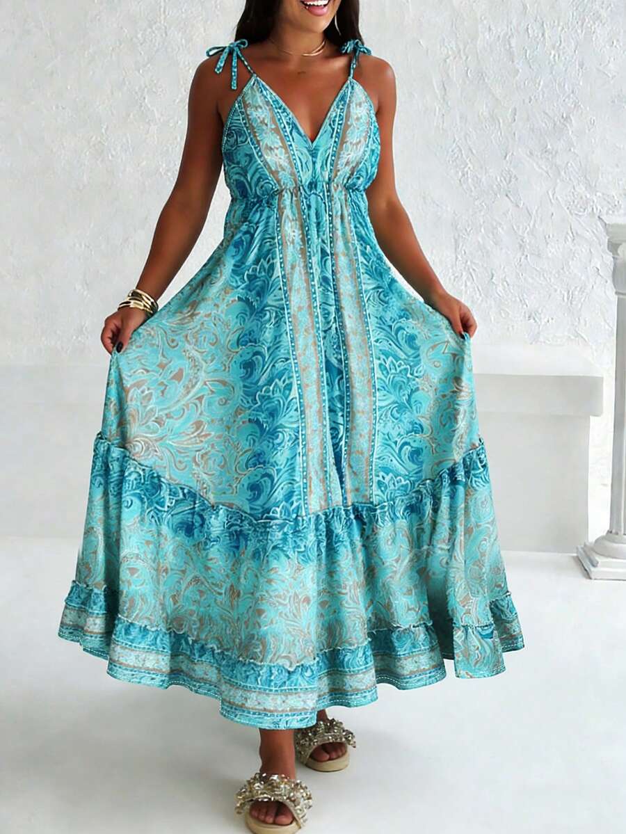 Chiếc đầm maxi phong cách Bohemian cỡ lớn này có cổ chữ V sâu quyến rũ và dây đeo vai mảnh mai. Họa tiết hoa màu xanh dương tuyệt đẹp trải dài xuống eo, tôn lên vóc dáng thanh lịch và quyến rũ.