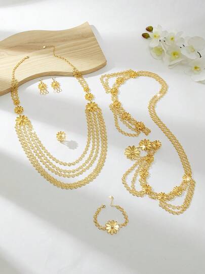 一套别致复古风金色铜质首饰套装，包括项链、手链、戒指和耳环，适合户外活动、休闲聚会、日常佩戴、节日庆典，是送给女性、女友或父母的理想礼物。